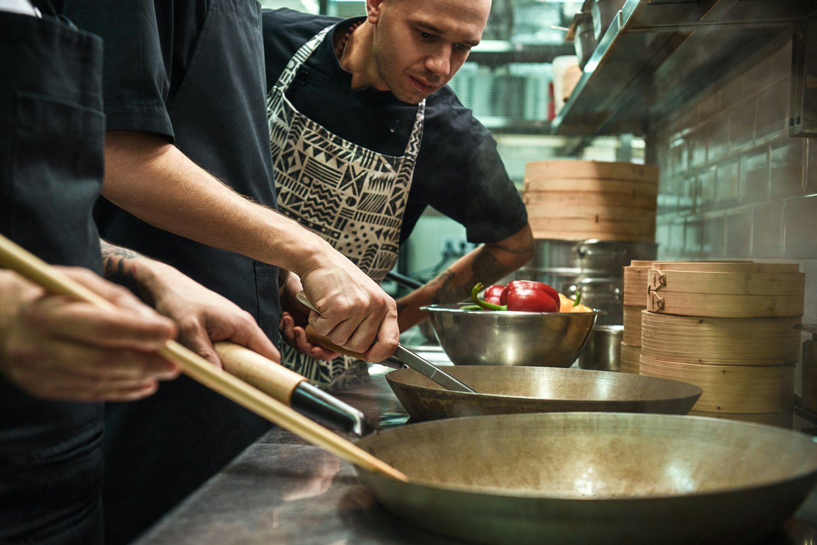 Everything should be perfect. Restaurant chef looking his assistants cooking a new dish in a kitchen