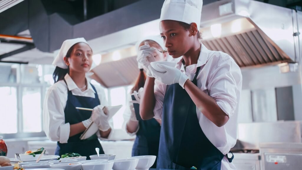 Group of schoolgirls having fun learning to cook. Female students in a cooking class.